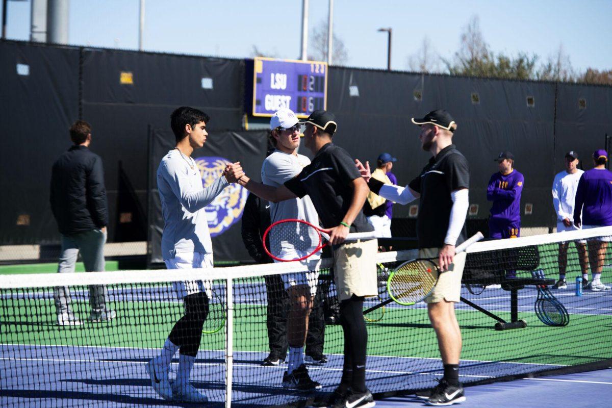 LSU men's tennis sophomore Joao Garca and junior Nick Watson shake hands with Purdue men’s tennis junior Sebastian Welch and junior Tomasz Dudek at the conclusion of their doubles match Sunday, Feb. 13, 2021 during LSU's 6-1 win over Purdue at the LSU Tennis Complex on Gourrier Avenue in Baton Rouge, La.