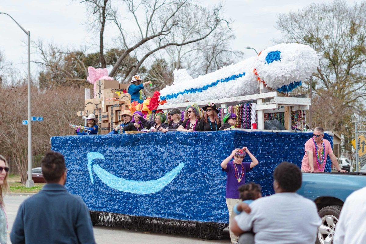 Krewe throws beads from an Amazon inspired float on Sunday, Feb. 20, 2022, as part of the Mid City Gras parade on North Boulevard in Baton Rouge, La.