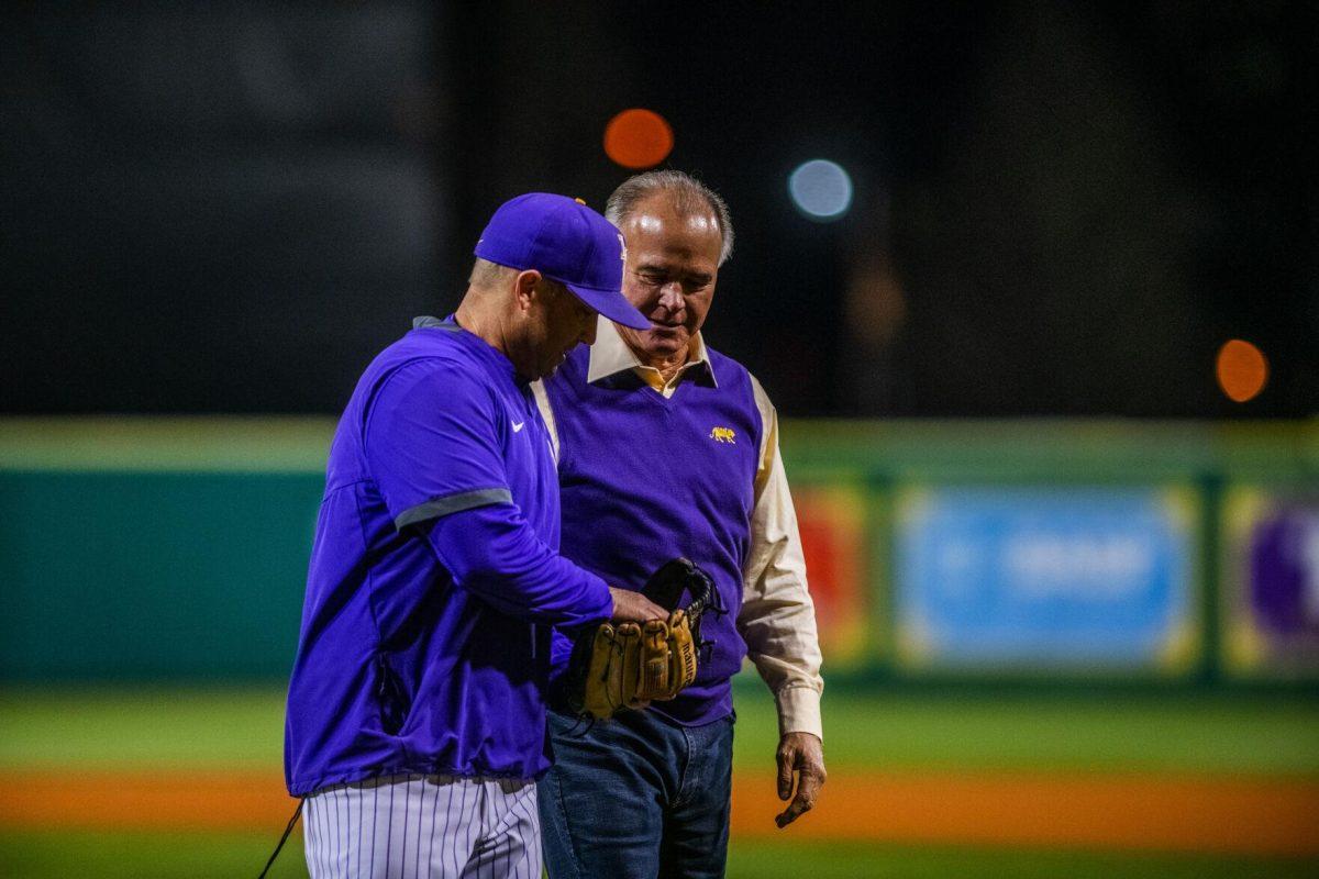 Former head coach Paul Mainieri and LSU head coach Jay Johnson walk back to the dugout Friday, Feb. 18, 2022 before LSU's 13-1 win against Maine at Alex Box Stadium on Gourrier Avenue in Baton Rouge, La.