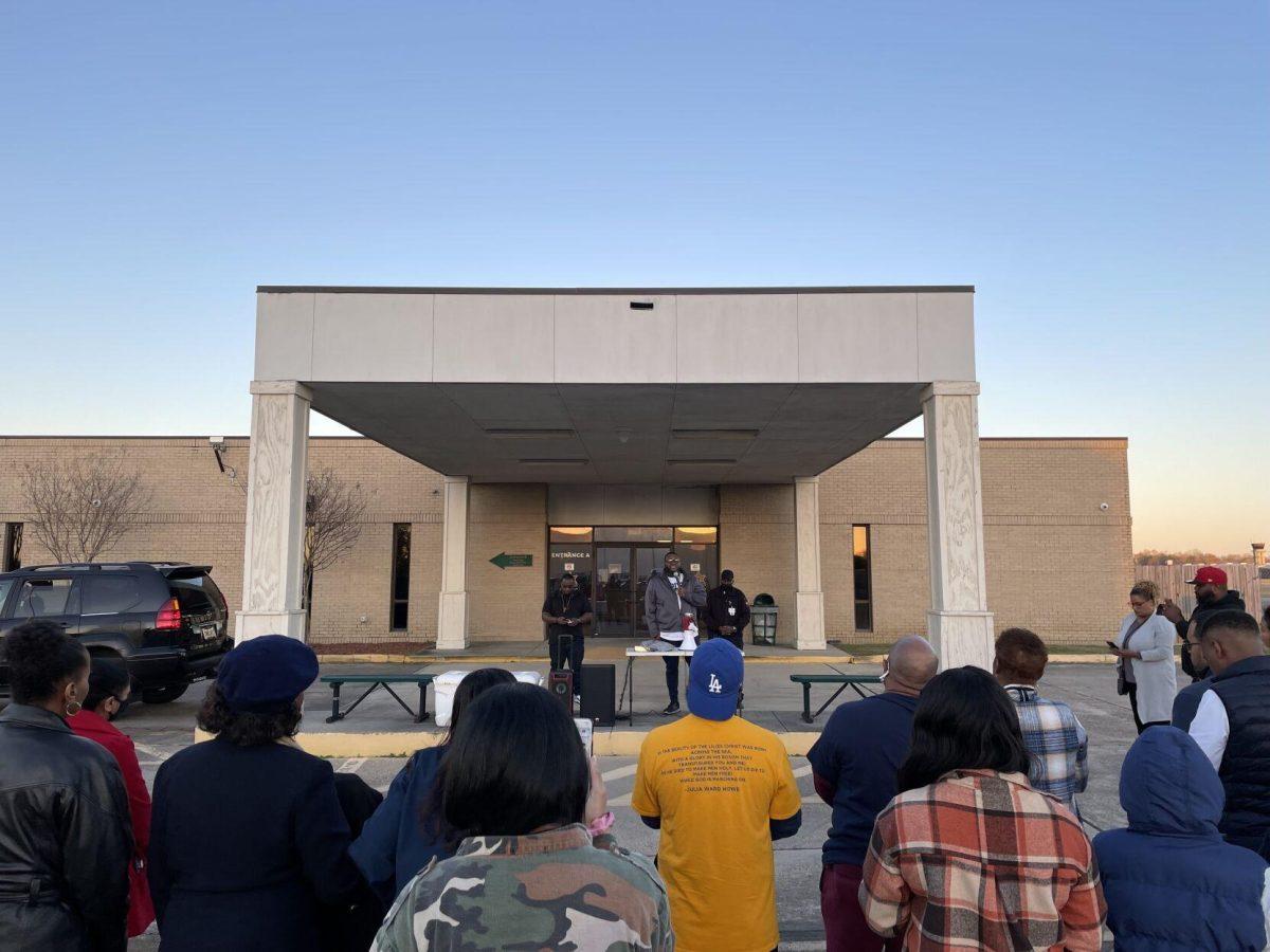 Protestors watch speaker at the EBR sheriff's office on Sunday.