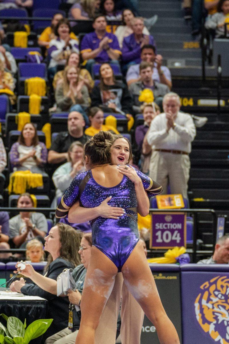 LSU gymnastics all-around freshman Aleah Finnegan hugs Assistant Coach Ashleigh Gnat after competing in the balance beam on Friday, March 4, 2022, during LSU gymnastics&#8217; 107.500-197.450 loss against Kentucky in the Pete Maravich Assembly Center on North Stadium Drive in Baton Rouge, La.