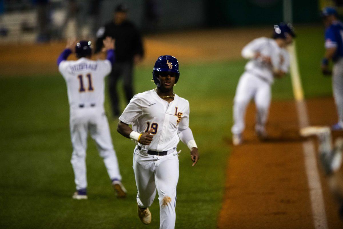 LSU baseball sophomore first baseman Tre Morgan III (18) scores Wednesday, March 2, 2022 before LSU's 11-3 win against UNO at Alex Box Stadium on Gourrier Avenue in Baton Rouge, La.