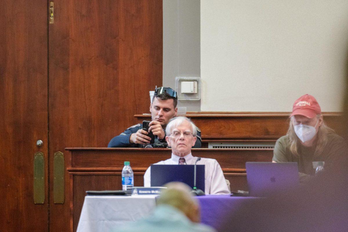 A police officer sits in during the LSU Faculty Senate meeting on Thursday, March 24, 2022, inside the LSU Law Center on Highland Road in Baton Rouge, La.