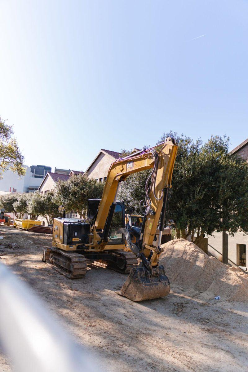 An excavator sits near a pile of sand on Sunday, March 20, 2022, at the LSU Studio Arts Buildings on South Campus Drive in Baton Rouge, La.