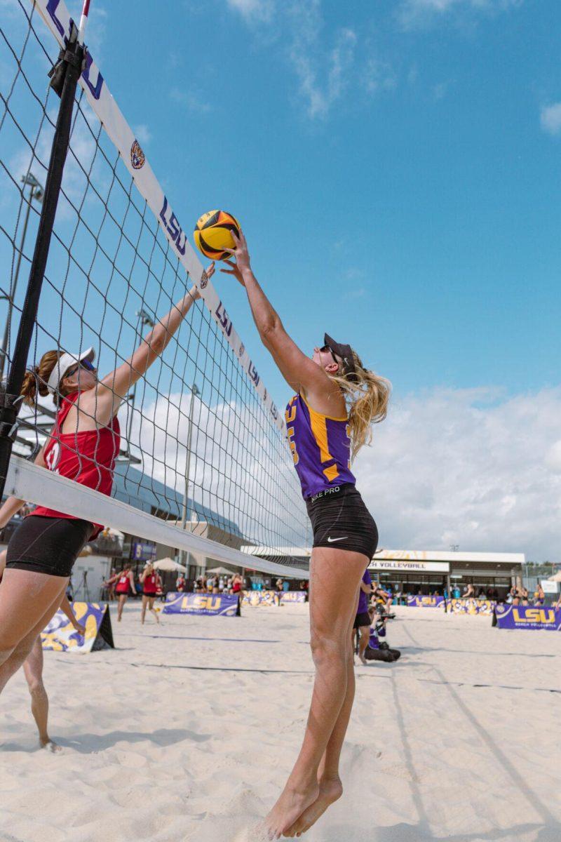 LSU beach volleyball redshirt sophomore Sierra Caffo (35) tips the ball over the net on Sunday, March 6, 2022, during LSU&#8217;s 3-2 win over Loyola Marymount at the Beach Volleyball Stadium on Cypress Drive in Baton Rouge, La.