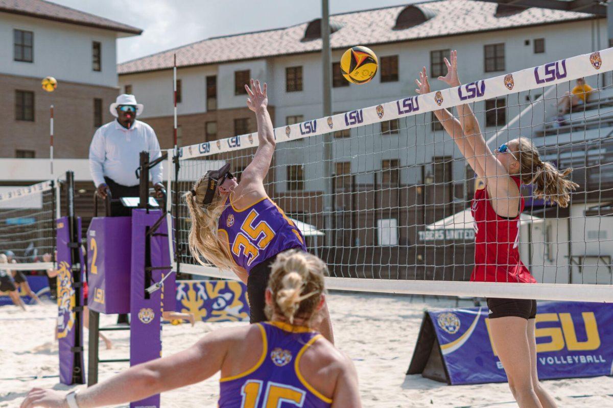 LSU beach volleyball redshirt sophomore Sierra Caffo (35) reaches one hand up to block the ball on Sunday, March 6, 2022, during LSU&#8217;s 3-2 win over Loyola Marymount at the Beach Volleyball Stadium on Cypress Drive in Baton Rouge, La.