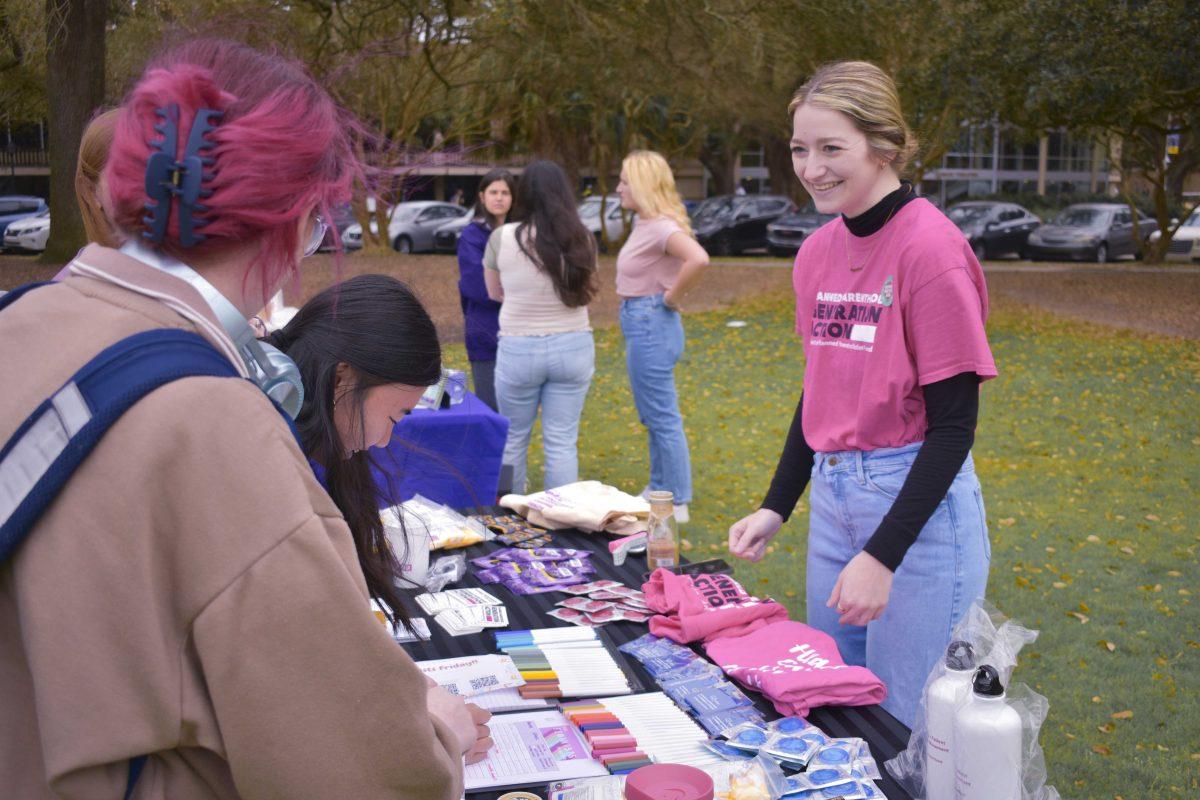 The LSU Feminist for Action organization sets up an information booth Tuesday, March 8, 2022, for the Women for the Win event on the Parade Ground on LSU&#8217;s campus in Baton Rouge, LA.