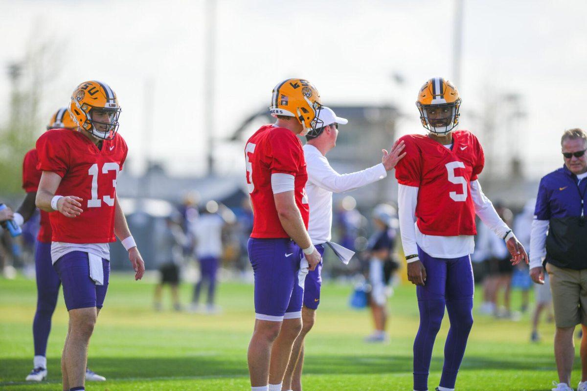 LSU football quarterbacks Myles Brennan (15) and Jayden Daniels (5) chat in between drills Tuesday, March 29, 2022 during LSU's spring practice in Baton Rouge, La.