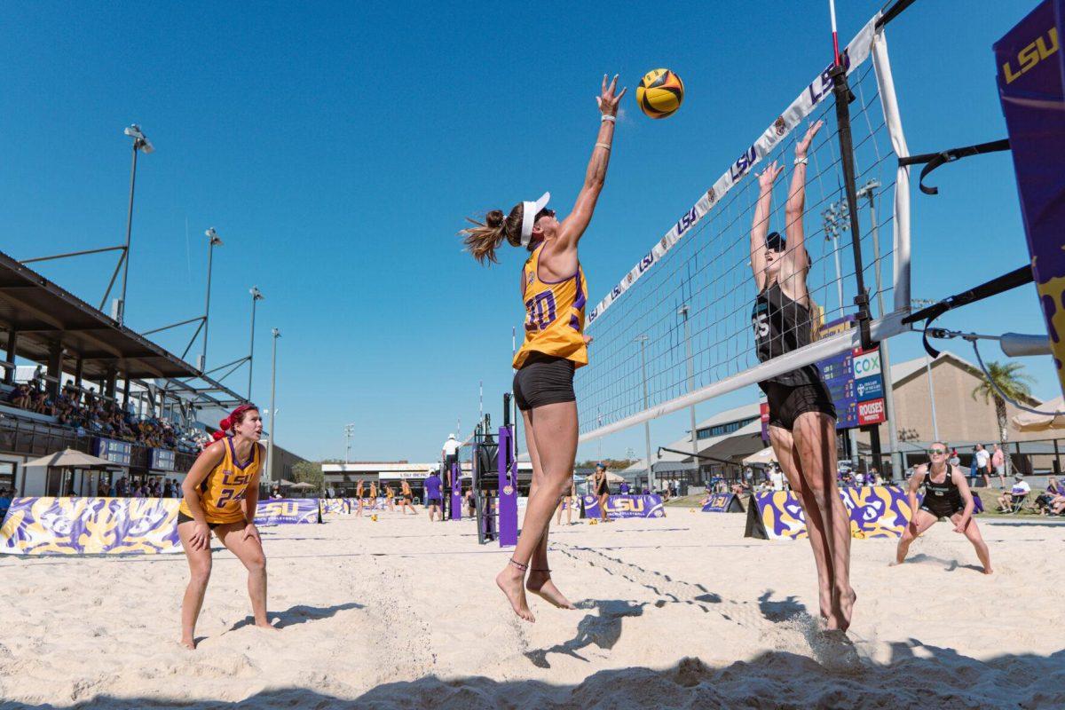 LSU beach volleyball graduate student Hannah Brister (30) hits the ball over the net on Sunday, March 27, 2022, during LSU&#8217;s 1-4 loss against TCU at the Beach Volleyball Stadium on Cypress Drive in Baton Rouge, La.