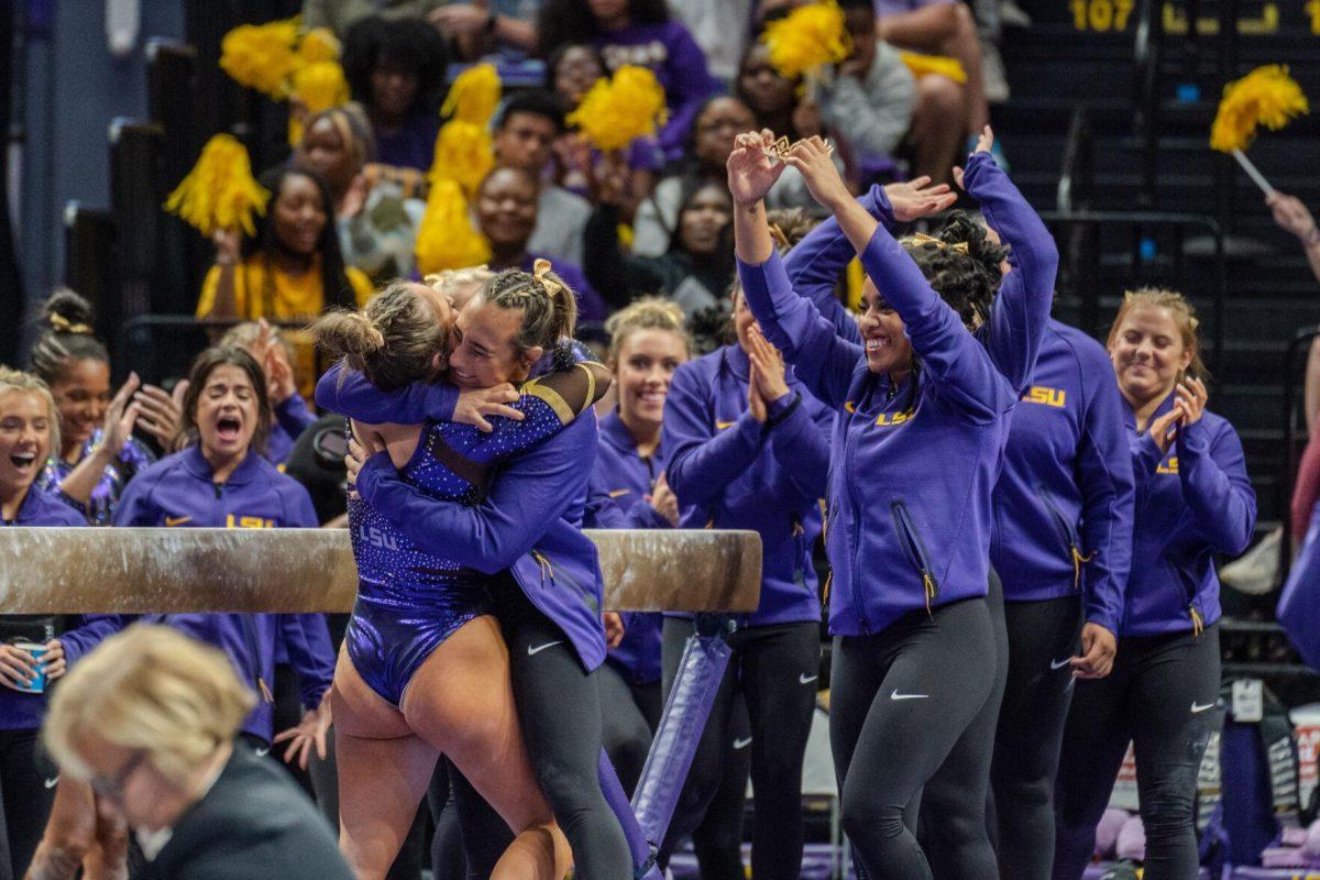 The LSU gymnastics team celebrates a well-done routine on Friday, March 4, 2022, during LSU gymnastics&#8217; 107.500-197.450 loss against Kentucky in the Pete Maravich Assembly Center on North Stadium Drive in Baton Rouge, La.