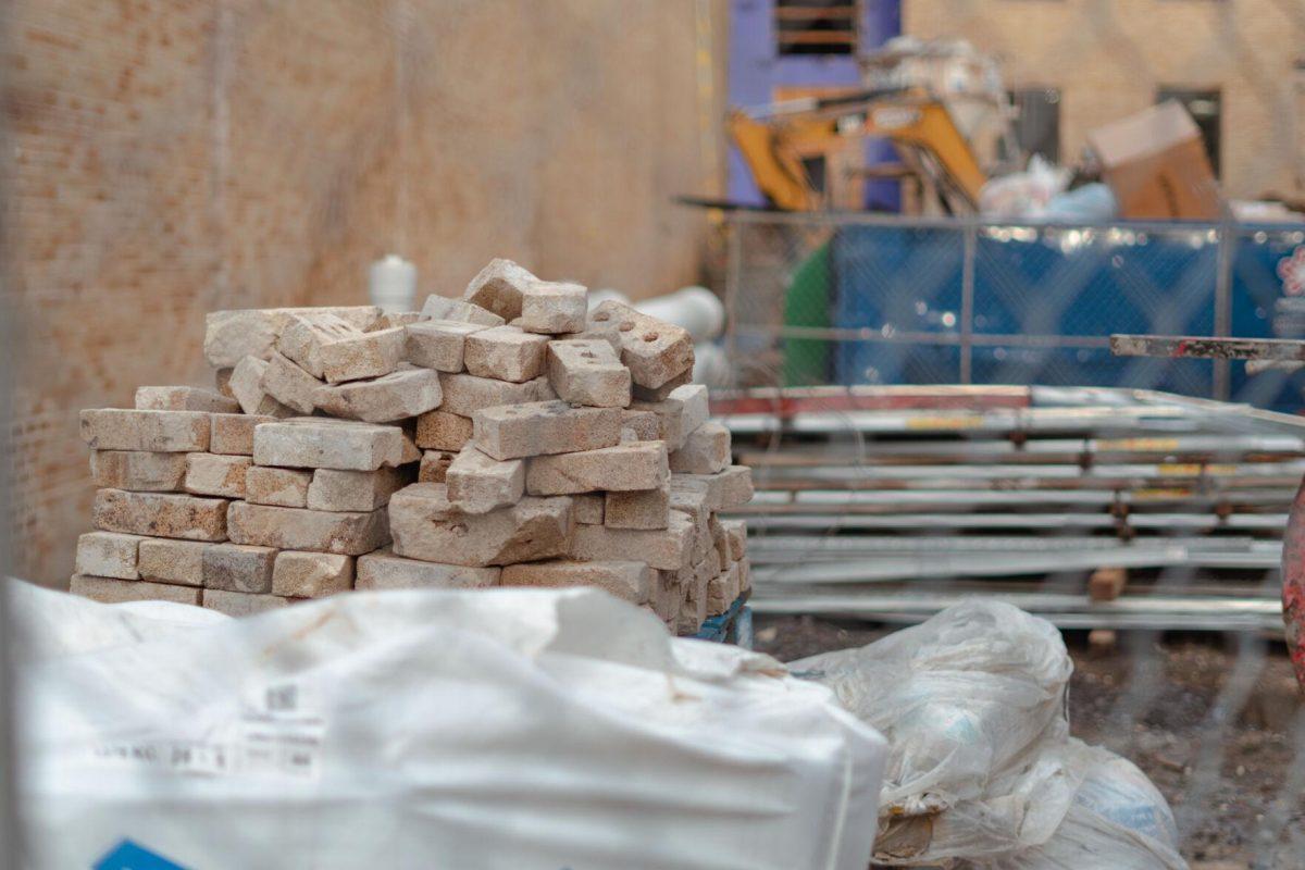 A pile of bricks sits amongst various construction materials on Tuesday, March 22, 2022, at the Huey P. Long Field House on Field House Drive in Baton Rouge, La.