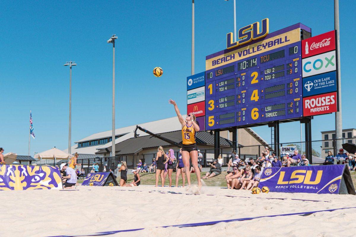 LSU beach volleyball sophomore Ellie Shank (15) serves the ball on Sunday, March 27, 2022, during LSU&#8217;s 1-4 loss against TCU at the Beach Volleyball Stadium on Cypress Drive in Baton Rouge, La.