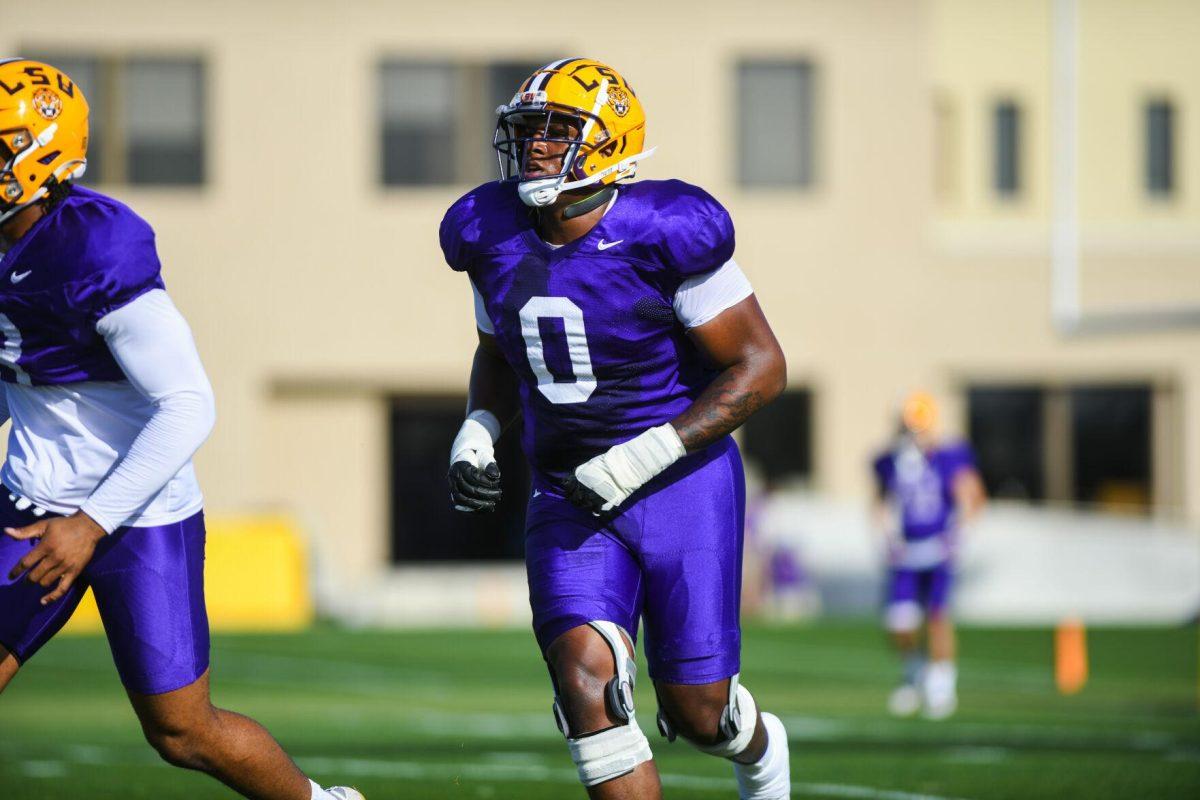 LSU football defensive lineman Maason Smith (0) runs to the huddle Tuesday, March 29, 2022 during LSU's spring practice in Baton Rouge, La.