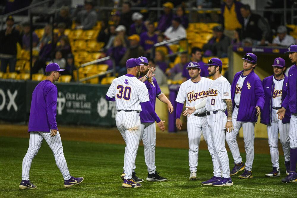 LSU baseball graduate student right-handed pitcher Trent Vietmeier (30) is welcomed back with high fives at the dugout Wednesday, March. 23, 2022 during LSU's 6-7 loss against Louisiana Tech at Alex Box Stadium on Gourrier Avenue in Baton Rouge, La.