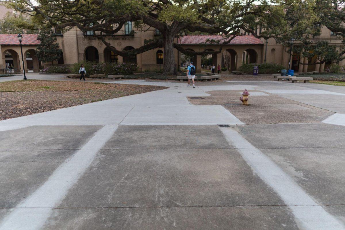 Students walk past new concrete on Monday, March 7, 2022, in the LSU Quad in Baton Rouge, La.