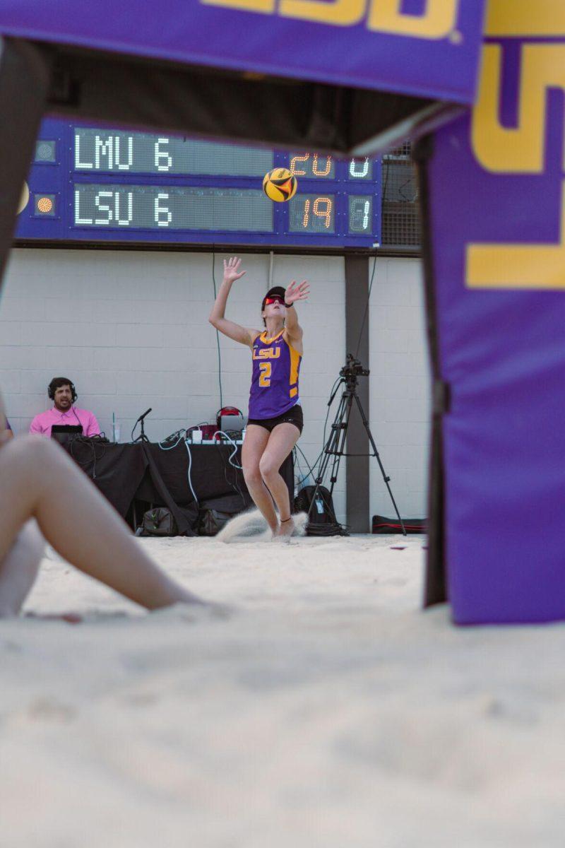 LSU beach volleyball redshirt junior Allison Coens (2) serves on Sunday, March 6, 2022, during LSU&#8217;s 3-2 win over Loyola Marymount at the Beach Volleyball Stadium on Cypress Drive in Baton Rouge, La.