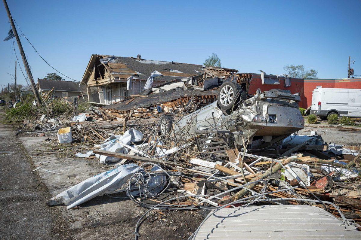 Debris surrounds extensive damage to homes after a tornado Tuesday night in Arabie, La., Wednesday, March 23, 2022. Louisiana is sending 300 National Guard troops to the New Orleans area where tornadoes flipped cars, ripped off rooftops. (Scott Clause /The Daily Advertiser via AP)