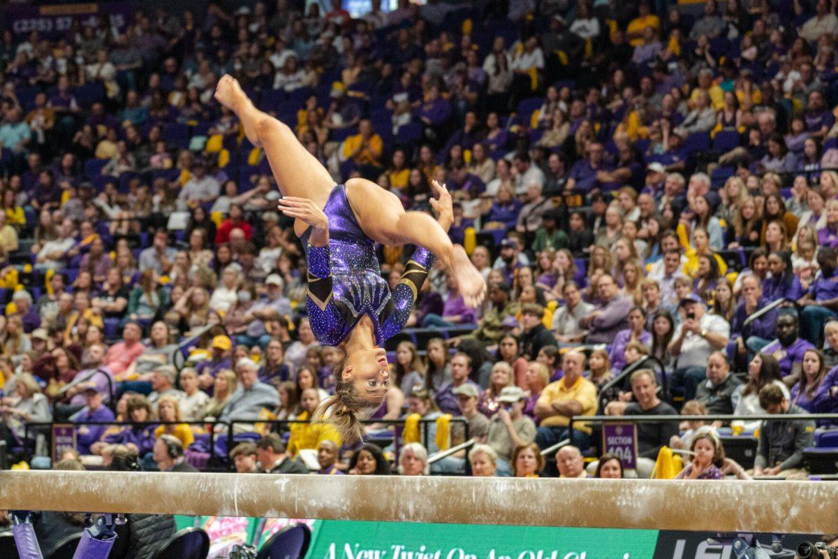 LSU gymnastics graduate student Bridget Dean performs a flip on the balance beam on Friday, March 4, 2022, during LSU gymnastics&#8217; 107.500-197.450 loss against Kentucky in the Pete Maravich Assembly Center on North Stadium Drive in Baton Rouge, La.