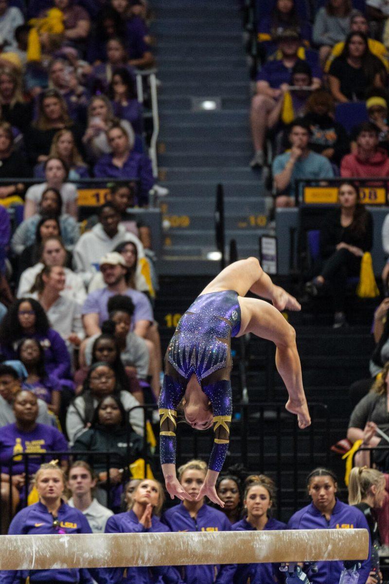 LSU gymnastics all-around sophomore Elena Arenas performs a flip on the balance beam on Friday, March 4, 2022, during LSU gymnastics&#8217; 107.500-197.450 loss against Kentucky in the Pete Maravich Assembly Center on North Stadium Drive in Baton Rouge, La.