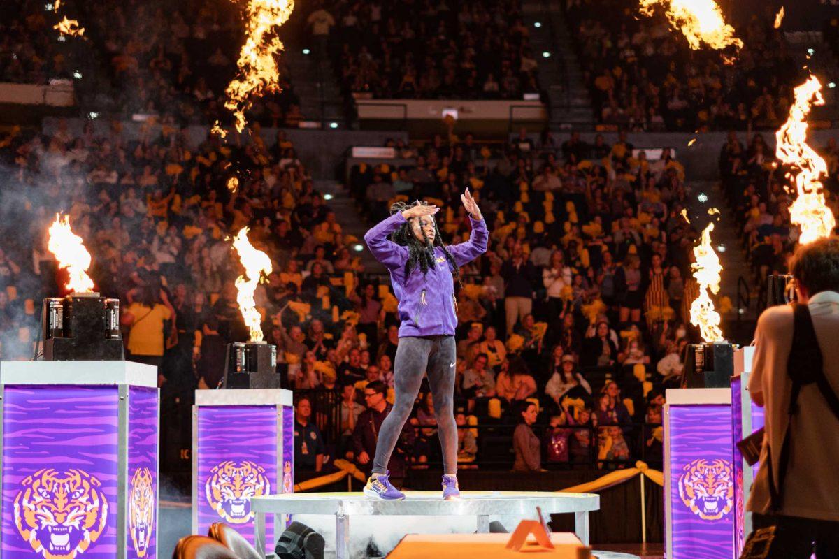 LSU gymnastics all-around junior Kiya Johnson stands among flames for introductions on Friday, March 4, 2022, during LSU gymnastics&#8217; 107.500-197.450 loss against Kentucky in the Pete Maravich Assembly Center on North Stadium Drive in Baton Rouge, La.