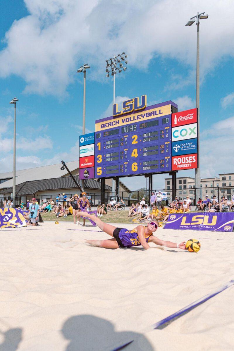 LSU beach volleyball sophomore Ellie Shank (15) dives for the ball on Sunday, March 6, 2022, during LSU&#8217;s 3-2 win over Loyola Marymount at the Beach Volleyball Stadium on Cypress Drive in Baton Rouge, La.