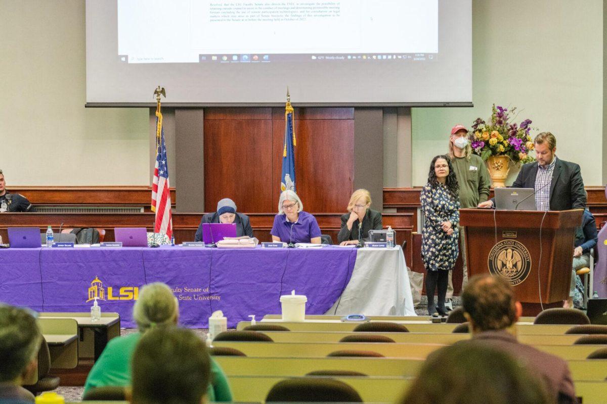 A Faculty Senator reads a resolution on Thursday, March 24, 2022, inside the LSU Law Center on Highland Road in Baton Rouge, La.