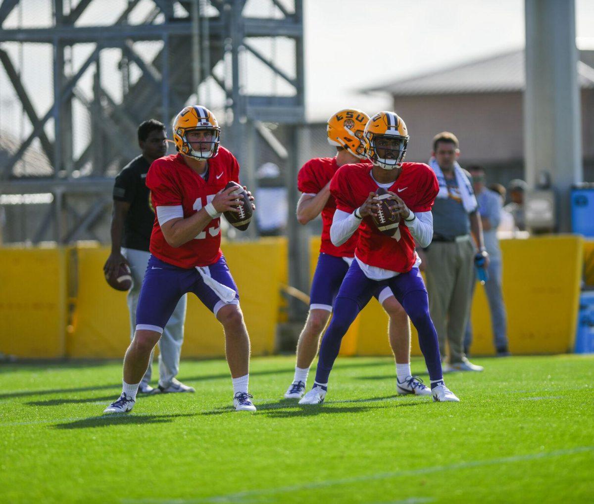 LSU football quarterbacks Myles Brennan (15) and Jayden Daniels (5) look for a receiver Tuesday, March 29, 2022 during LSU's spring practice in Baton Rouge, La.