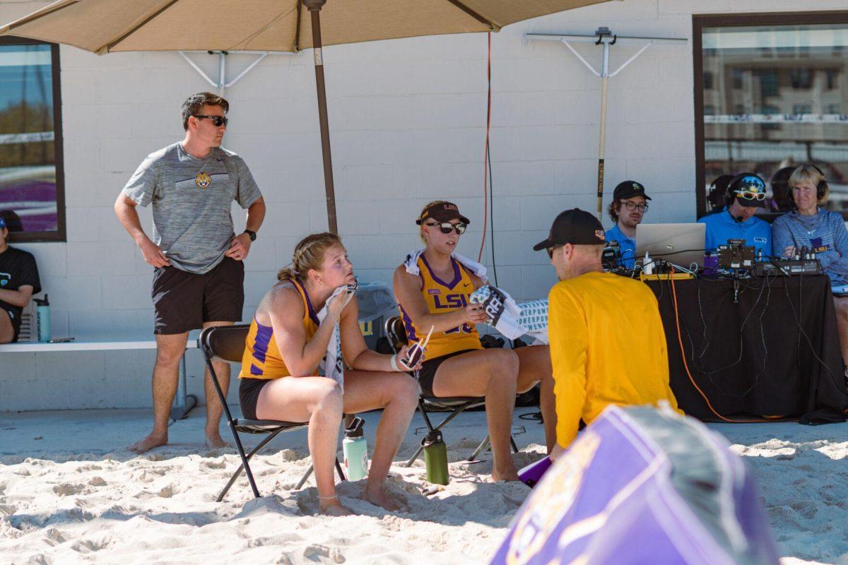 LSU beach volleyball Head Coach Russell Brock speaks with two players on Sunday, March 27, 2022, during LSU&#8217;s 1-4 loss against TCU at the Beach Volleyball Stadium on Cypress Drive in Baton Rouge, La.