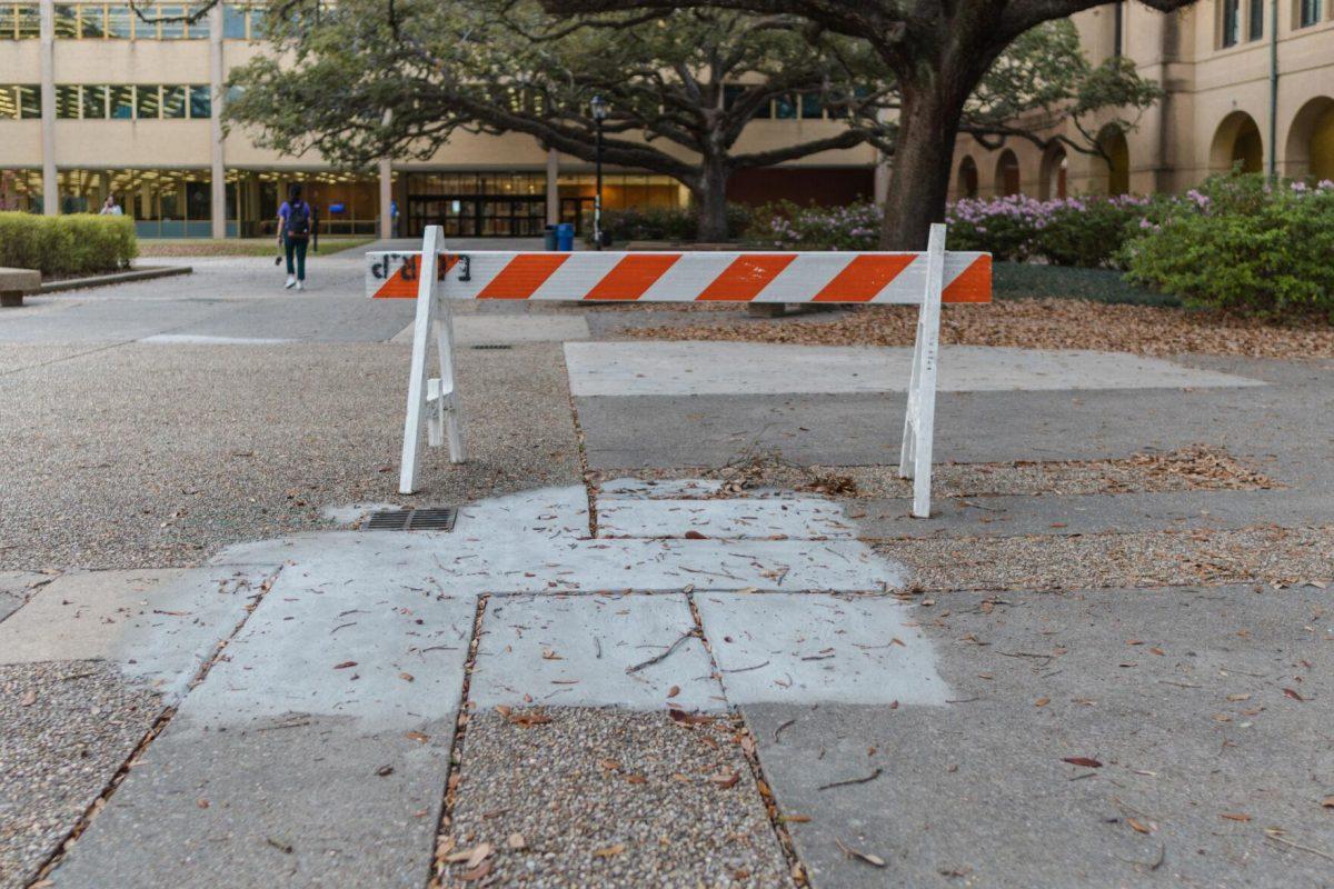 A barricade blocks one side of fresh concrete on Monday, March 7, 2022, in the LSU Quad in Baton Rouge, La.