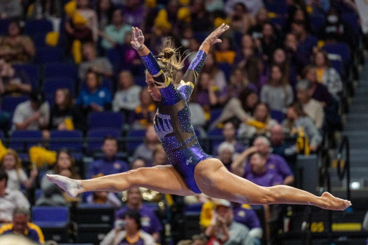 LSU gymnastics balance beam and floor exercise graduate student Christiana Desiderio executes a split in midair on Friday, March 4, 2022, during LSU gymnastics&#8217; 107.500-197.450 loss against Kentucky in the Pete Maravich Assembly Center on North Stadium Drive in Baton Rouge, La.