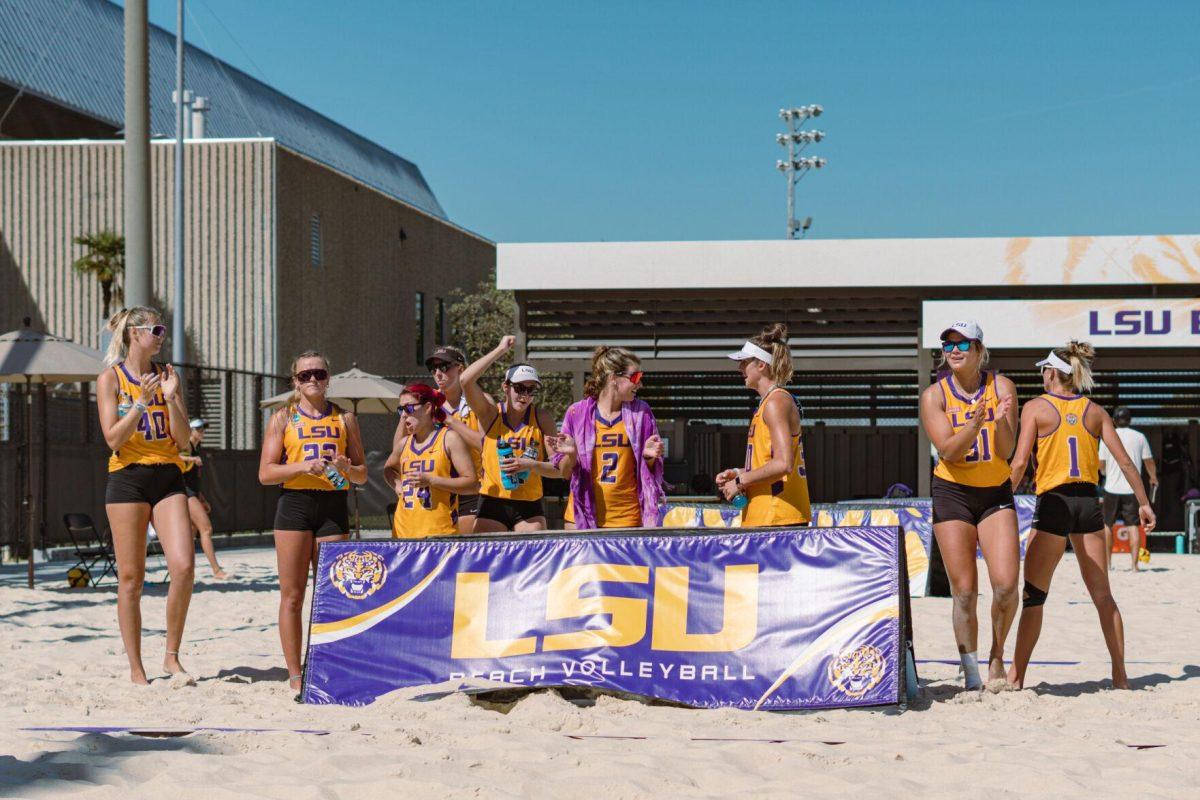 Members of the LSU beach volleyball team cheer for their teammates on Sunday, March 27, 2022, during LSU&#8217;s 1-4 loss against TCU at the Beach Volleyball Stadium on Cypress Drive in Baton Rouge, La.