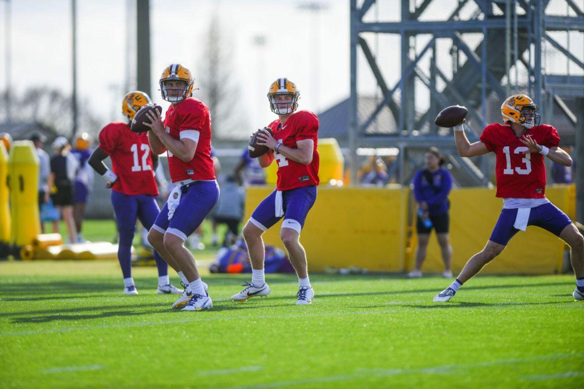 LSU football quarterbacks Garrett Nussmeier (13), Walker Howard (14), and Myles Brennan (15) prepare to throw the ball Tuesday, March 29, 2022 during LSU's spring practice in Baton Rouge, La.