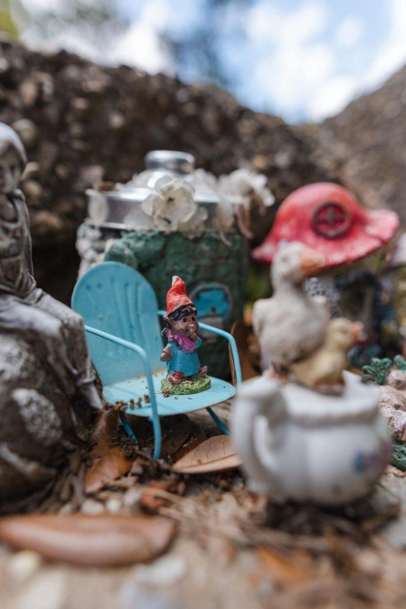 A gnome lounges in a blue chair on Thursday, March 24, 2022, in the Fairy Garden on LSU&#8217;s campus in Baton Rouge, La.