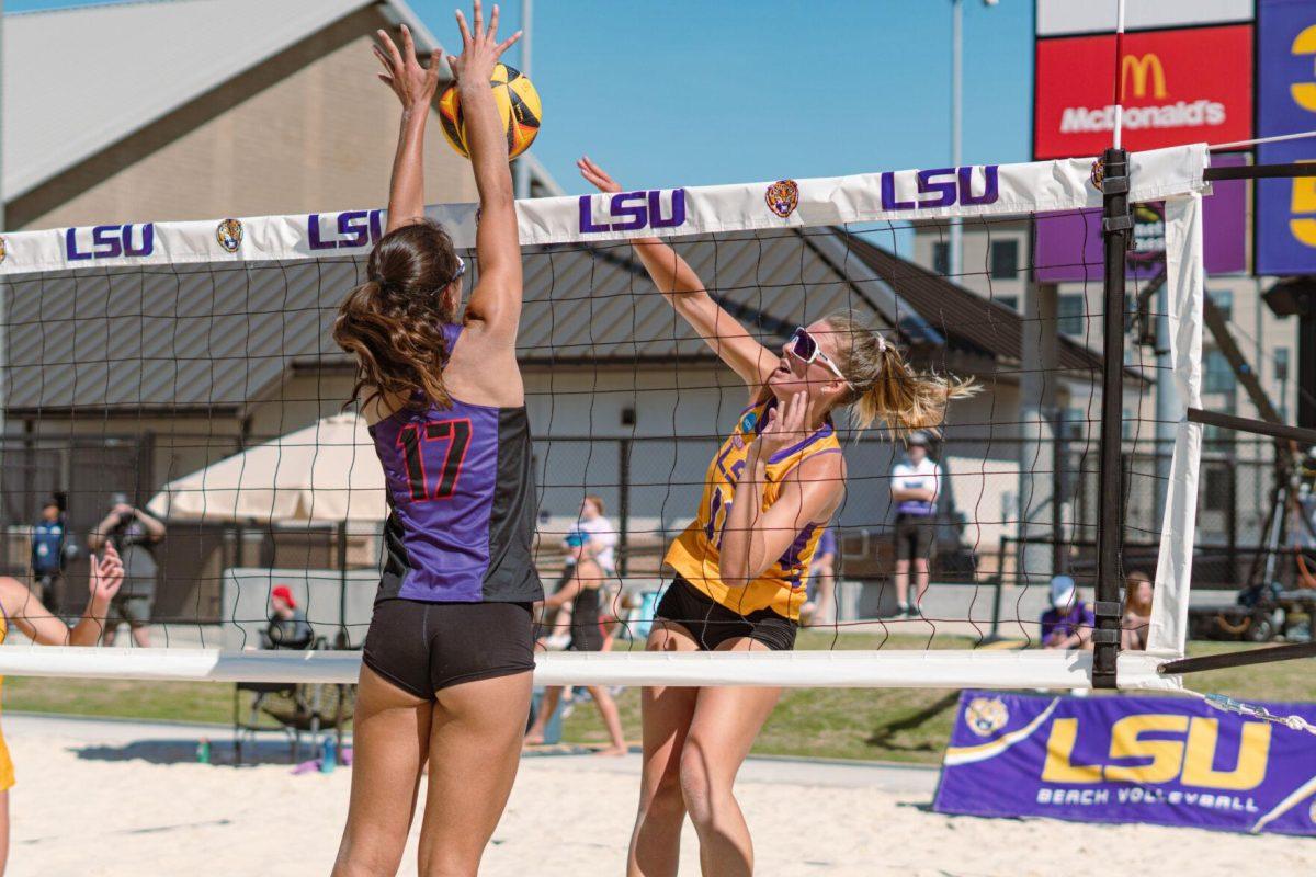 A TCU player blocks LSU beach volleyball junior Grace Seits&#8217; (11) hit on Sunday, March 27, 2022, during LSU&#8217;s 1-4 loss against TCU at the Beach Volleyball Stadium on Cypress Drive in Baton Rouge, La.