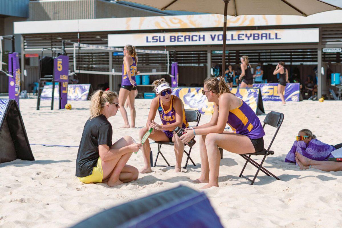 LSU beach volleyball assistant coach Cati Leak talks to two players on Sunday, March 6, 2022, during LSU&#8217;s 3-2 win over Loyola Marymount at the Beach Volleyball Stadium on Cypress Drive in Baton Rouge, La.