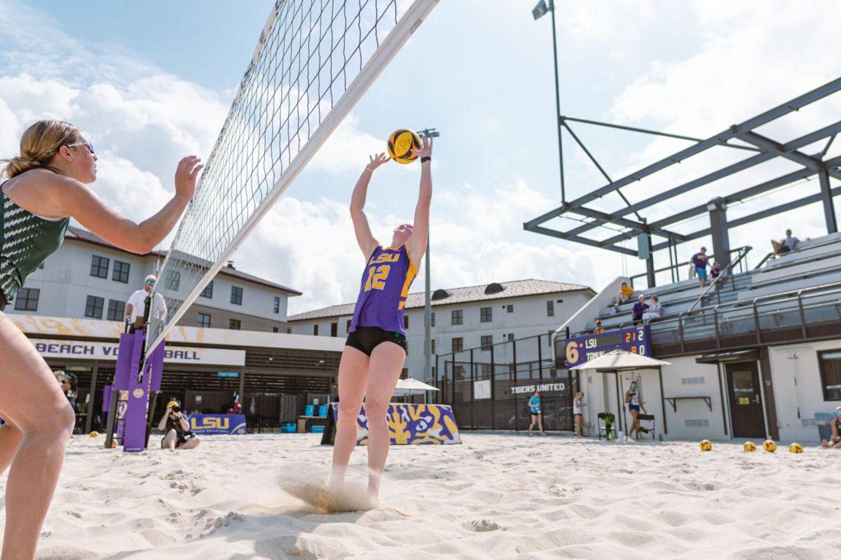 LSU beach volleyball sophomore Amber Haynes (12) tips the ball on Sunday, March 6, 2022, during LSU&#8217;s 3-2 win over Loyola Marymount at the Beach Volleyball Stadium on Cypress Drive in Baton Rouge, La.