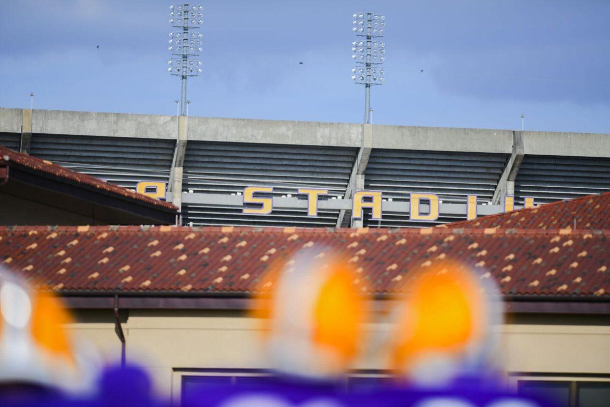 Tiger Stadium peaks in the background Tuesday, March 29, 2022 during LSU's spring practice in Baton Rouge, La.