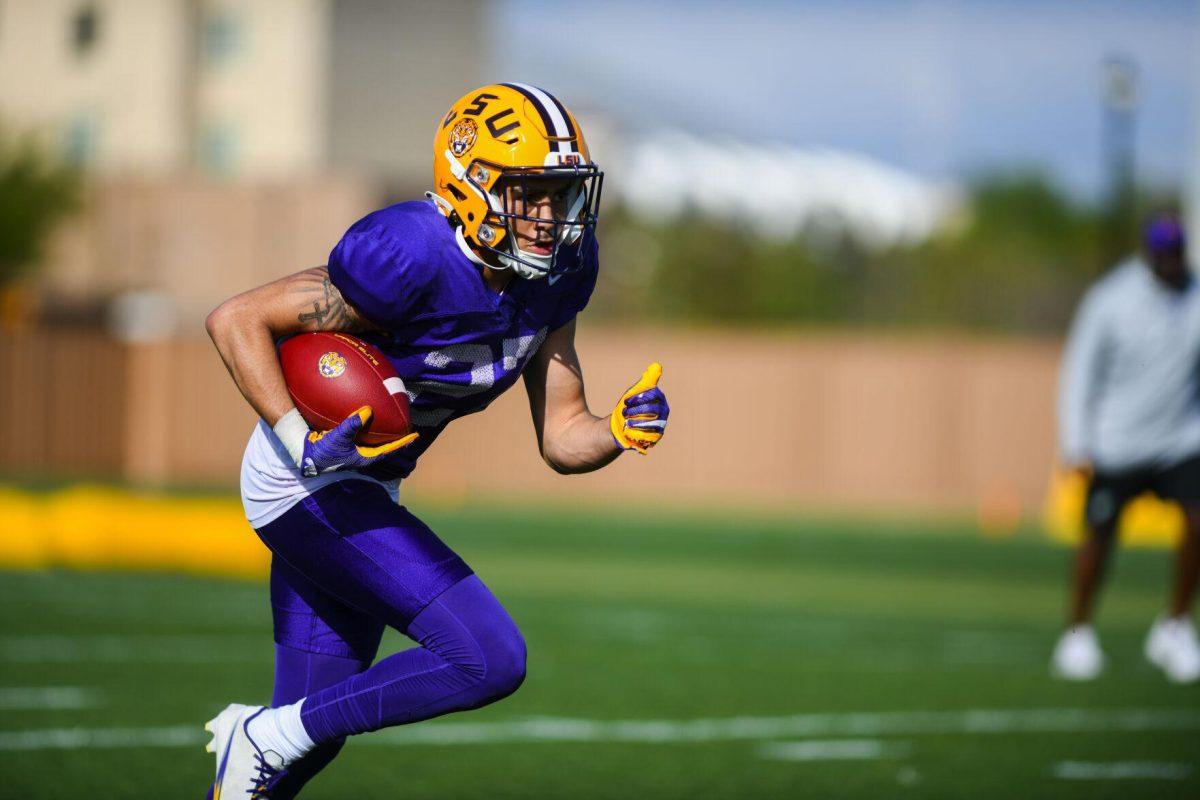 LSU football defensive back Ralph Walker (27) runs the ball Tuesday, March 29, 2022 during LSU's spring practice in Baton Rouge, La.