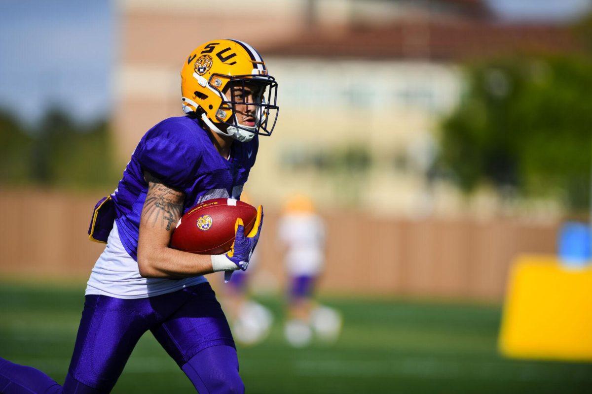 LSU football defensive back Ralph Walker (27) runs the ball Tuesday, March 29, 2022 during LSU's spring practice in Baton Rouge, La.