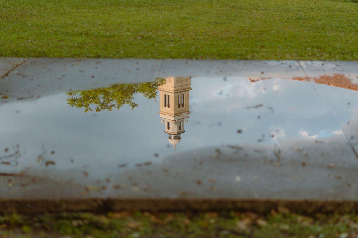 Memorial Tower reflects in a puddle on Tuesday, March 22, 2022, in the LSU Quad in Baton Rouge, La.