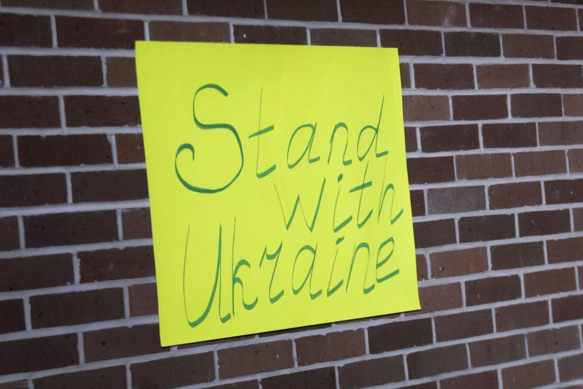 A sign that says "Stand with Ukraine" sits on the wall Friday, March 4, 2022 at the for the Ukraine supoort event at the LSU International Cultural Center on Dalrymple Drive in Baton Rouge, La.