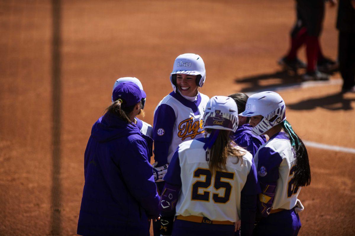 LSU softball head coach Beth Torina talks to redshirt sophomore infielder Taylor Pleasants (17), redshirt junior infielder Georgia Clark (25), and 5th-year senior pitcher/utility Shelbi Sunseri (27) Saturday, March 12, 2022 during LSU's 13-6 win against Alabama at Tiger Park in Baton Rouge, La.