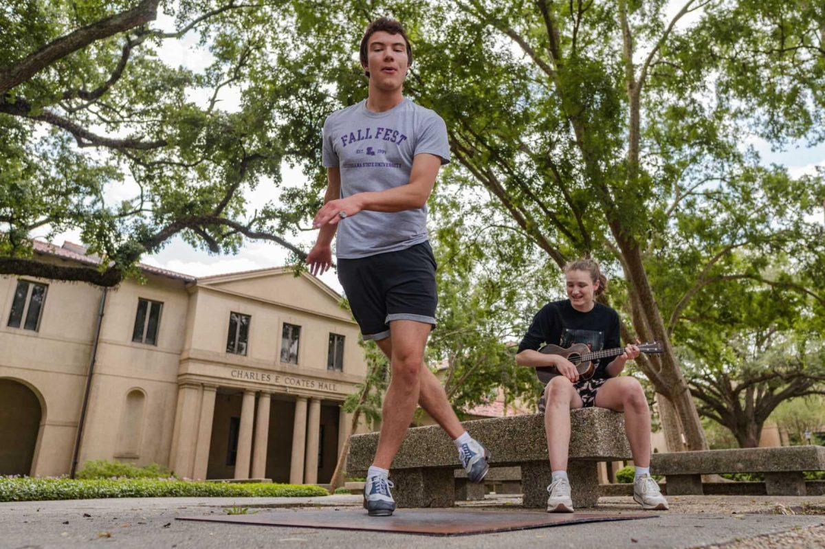 LSU sophomore math major Harrison Gietz (left) and sophomore film and tv major Jackie Johnston (right) perform a song and dance on Saturday, April 23, 2022, outside of Coates Hall in the Quad in Baton Rouge, La.