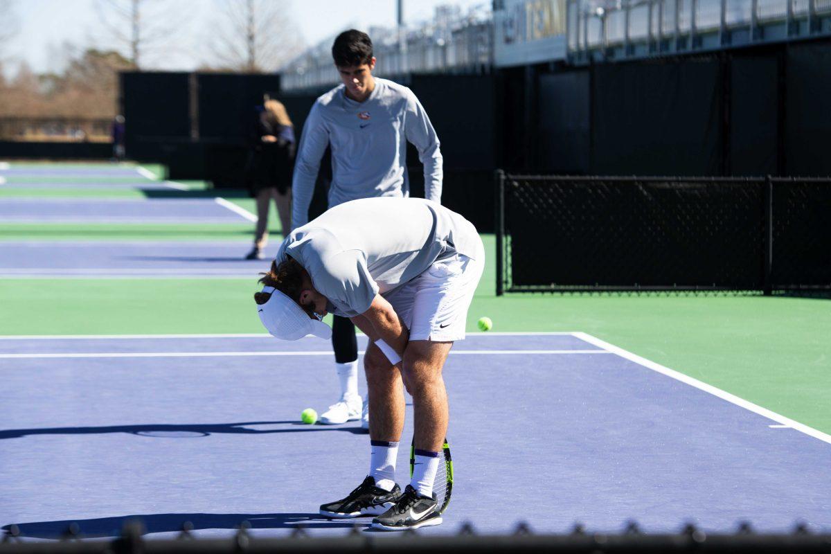 LSU men's tennis junior Nick Watson bends over Sunday, Feb. 13, 2021 during LSU's 6-1 win over Purdue at the LSU Tennis Complex on Gourrier Avenue in Baton Rouge, La.