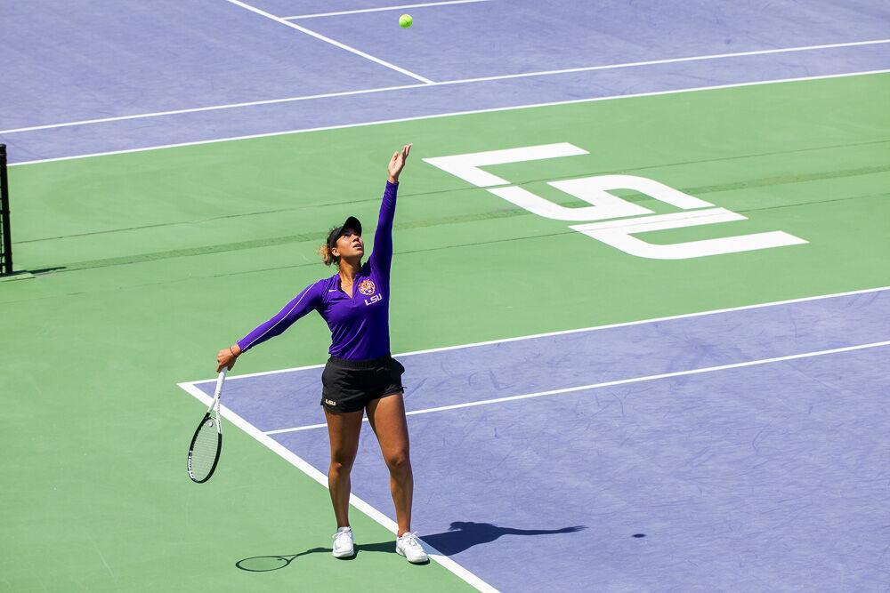 LSU women&#8217;s tennis junior Safiya Carrington tosses the ball up to serve Friday, April 8, 2022, during LSU&#8217;s 7-0 loss against Texas A&amp;M in the LSU Tennis Complex on Gourrier Avenue in Baton Rouge.