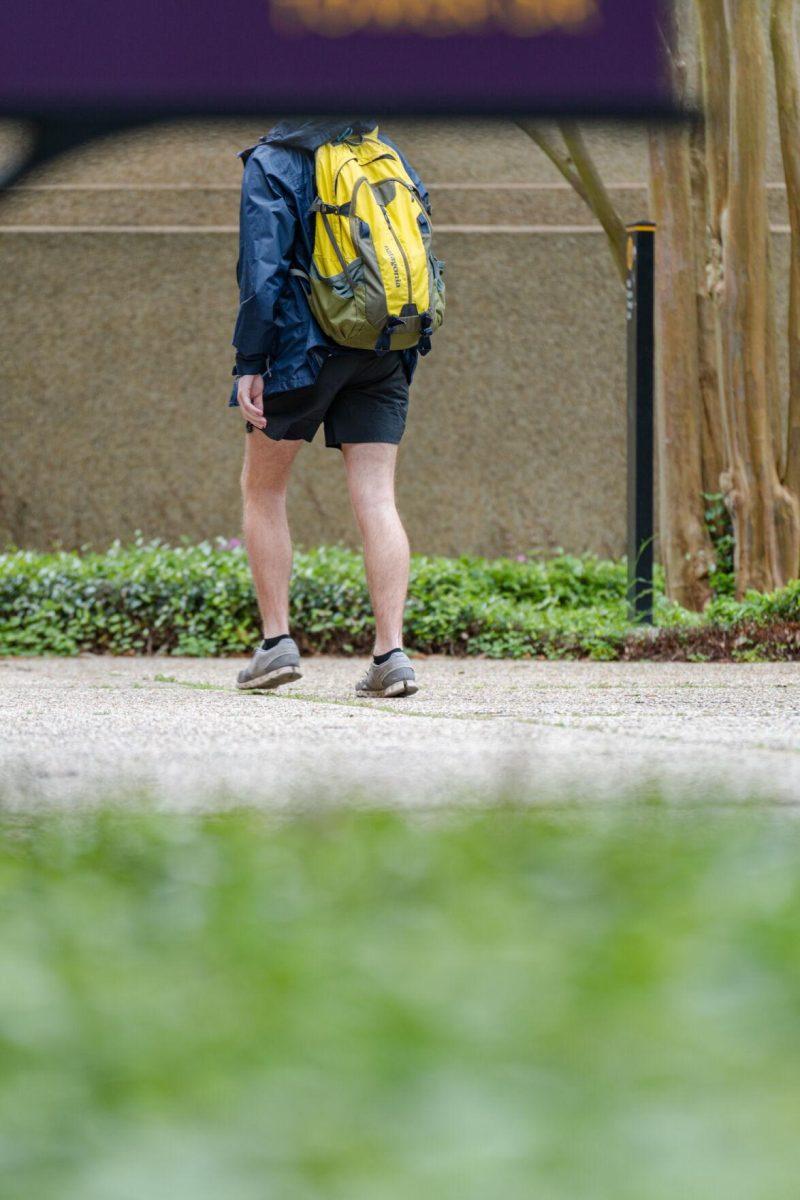 The Nicholson Hall sign blocks a student&#8217;s head from view on Tuesday, April 12, 2022, in the LSU Quad in Baton Rouge, La.