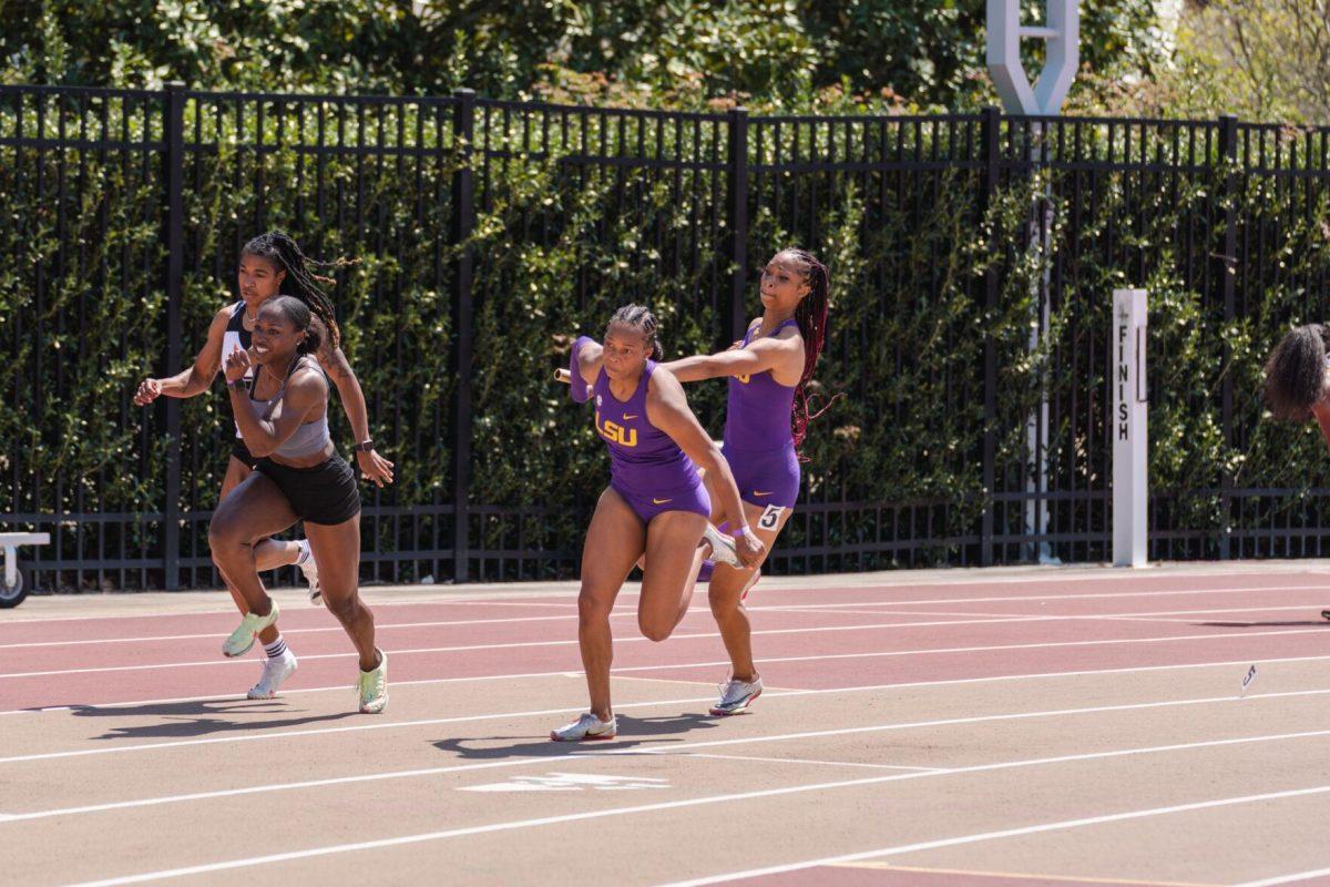 LSU track and field sprints sophomore Leah Phillips hands the baton to sprints sophomore Tionna Beard-Brown on Saturday, April 2, 2022, during the women&#8217;s 4x100m relay at the Battle on the Bayou track meet at Bernie Moore Stadium in Baton Rouge, La.