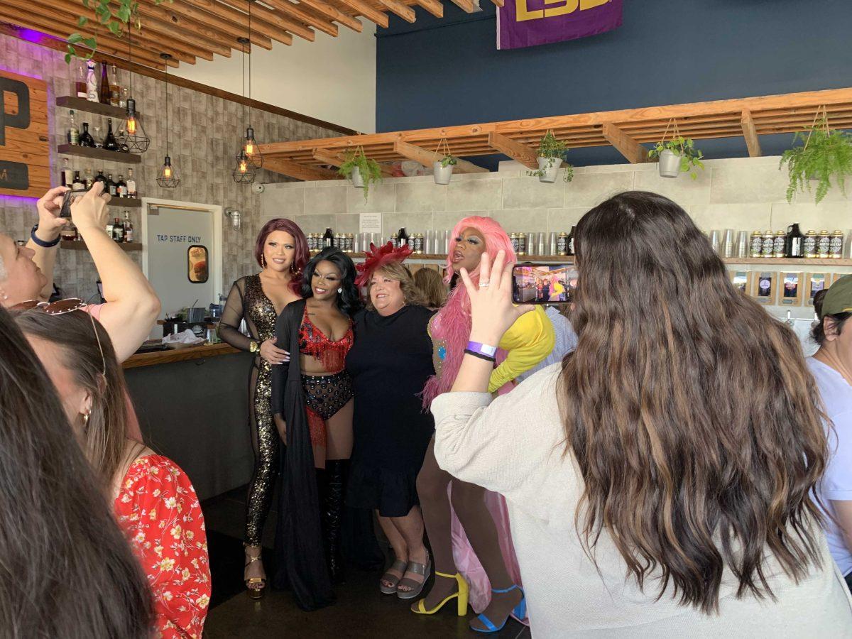 Drag queens Connie Hung, Mahogany Campbell and Queen Essence Hall pose with an audience member.&#160;&#160;