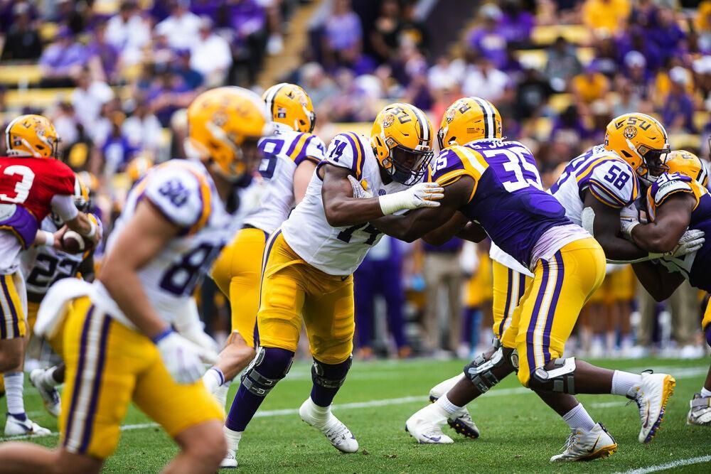 LSU football sophomore offensive line Marcus Dumervil (74) blocks to protect the run Saturday, April 23, 2022, during LSU football&#8217;s annual spring football game with White winning 51-31 over Purple in Tiger Stadium.