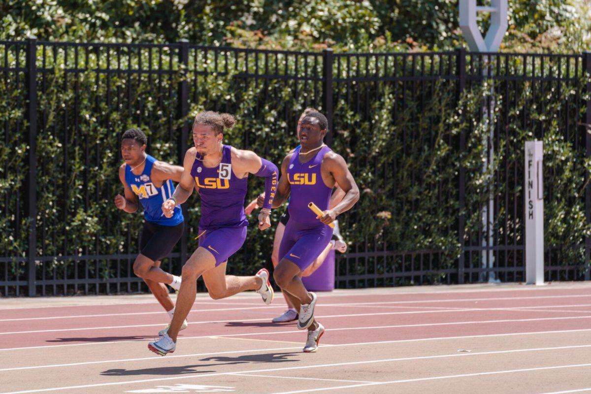 LSU track and field sprints sophomore Da&#8217;Marcus Fleming hands the baton to sprints junior Ashton Hicks on Saturday, April 2, 2022, during the men&#8217;s 4x100m relay at the Battle on the Bayou track meet at Bernie Moore Stadium in Baton Rouge, La.